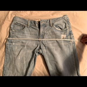 Old Navy Distressed jeans, with distressed holes in legs. Light blue in color.